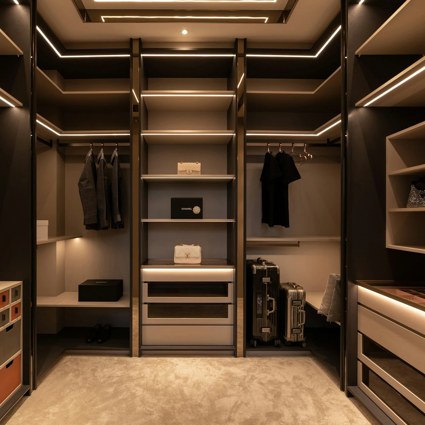 Organized walk in closet with fitted shelves and drawers